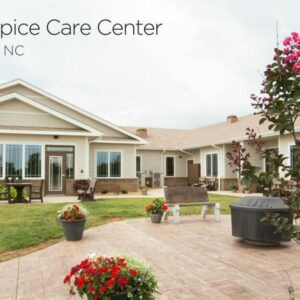 exterior of a hospice home with rose bushes