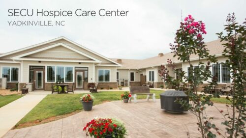 exterior of a hospice home with rose bushes