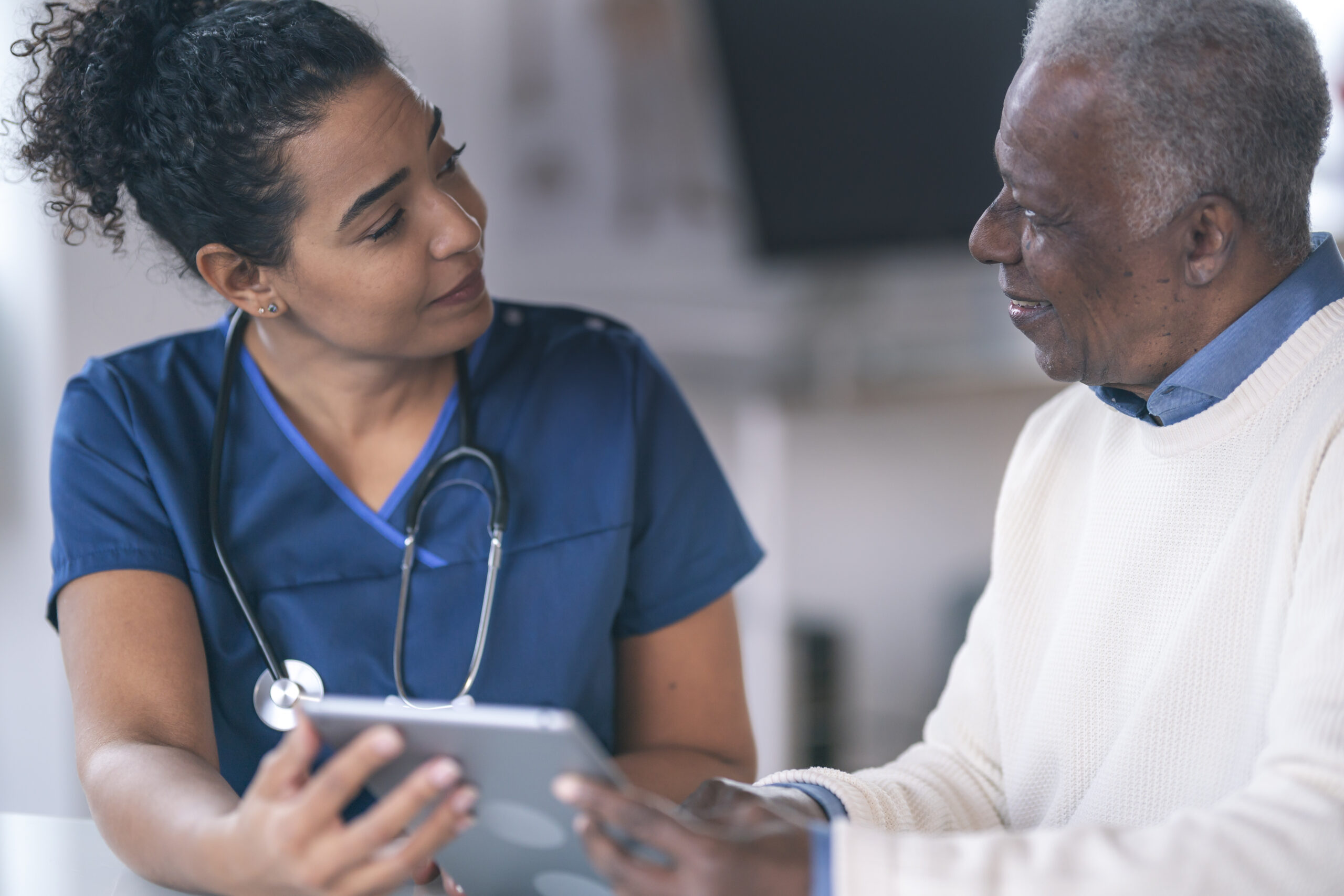 Female doctor consulting senior patient